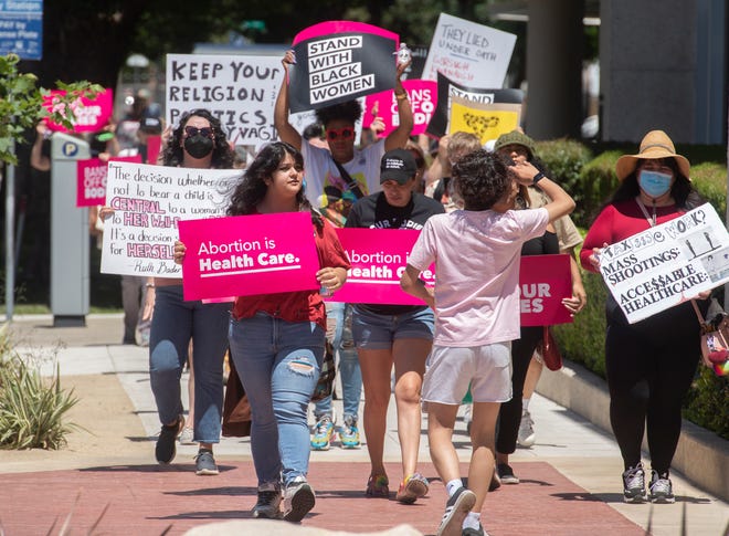 A group of about 75 people protesting for abortion rights march from Fremont Square Park to the San Joaquin County Courthouse.