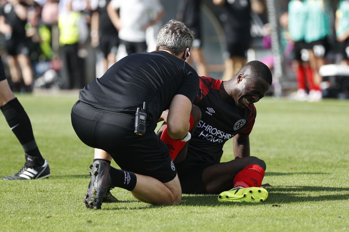Dan Udoh of Shrewsbury Town is treated for an injury (AMA)