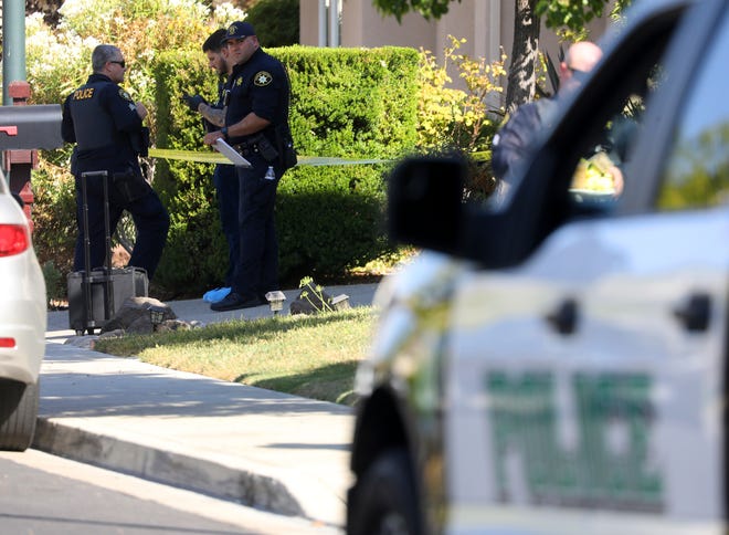 Police officers work the scene of a double homicide at a home on Wednesday, Sept. 7, 2022, in Dublin, Calif.  Devin Williams Jr., an Alameda County Deputy Sheriff, is accused of double-slaying.