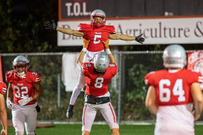 Lincoln High's Tristyn Quintana lifts up Tyrone De Loney after he returned the opening kickoff for a TD against Tracy High on Friday, Sept. 30, 2022. Tracy led 21-6 at the half.