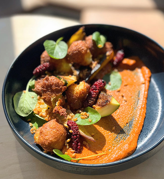 Squash beignets, pickled mulberries, puffed einkorn and romesco from Faria Bakery