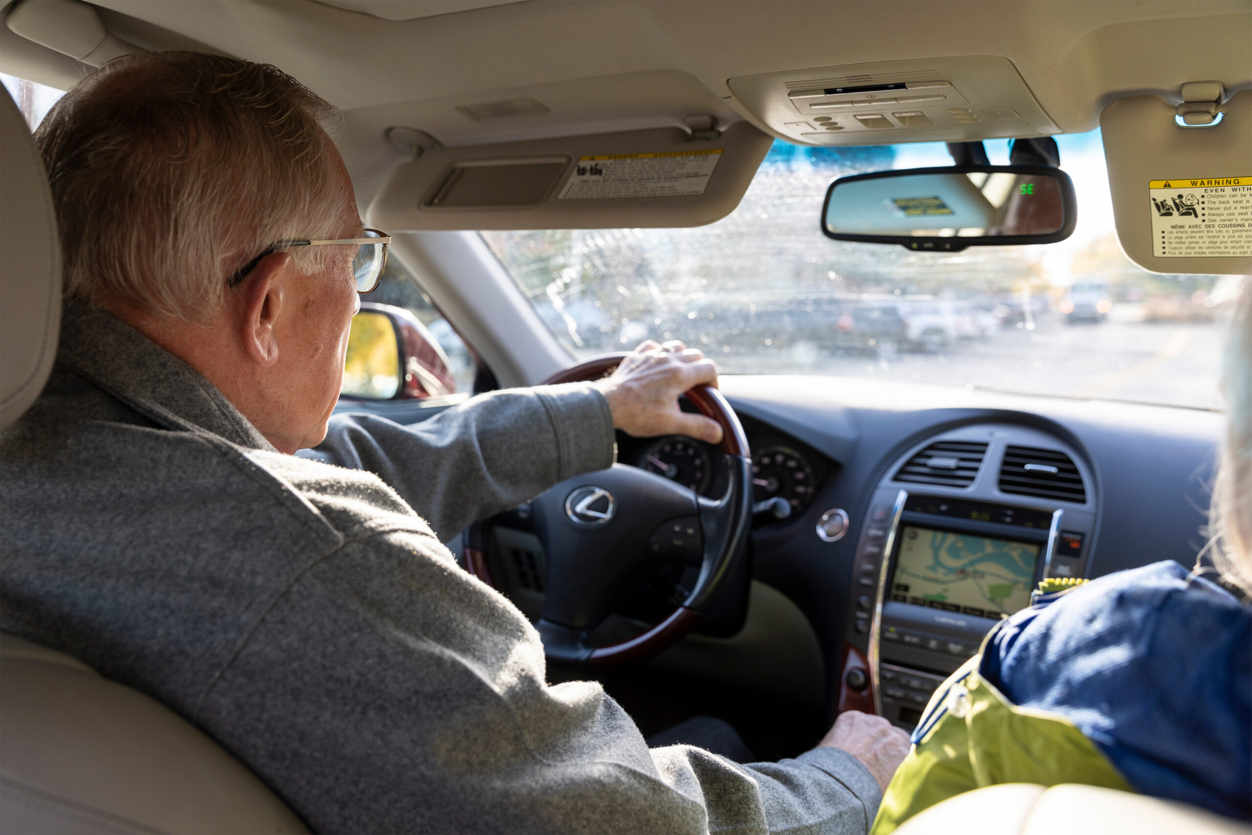 A photo shows Jim Maybach driving inside his car from behind.