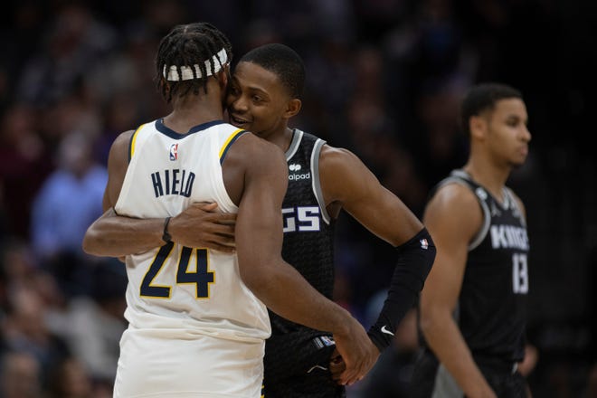 Buddy Hield embraces former teammate De'Aaron Fox Wednesday in Sacramento.