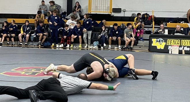 Lena-Winslow/Stockton senior heavyweight Henry Engel puts the finishing touches on his 10-second pin during a dual in Lena against Sterling on Dec.  15, 2022. Engel has 11 first-period pins this season already.