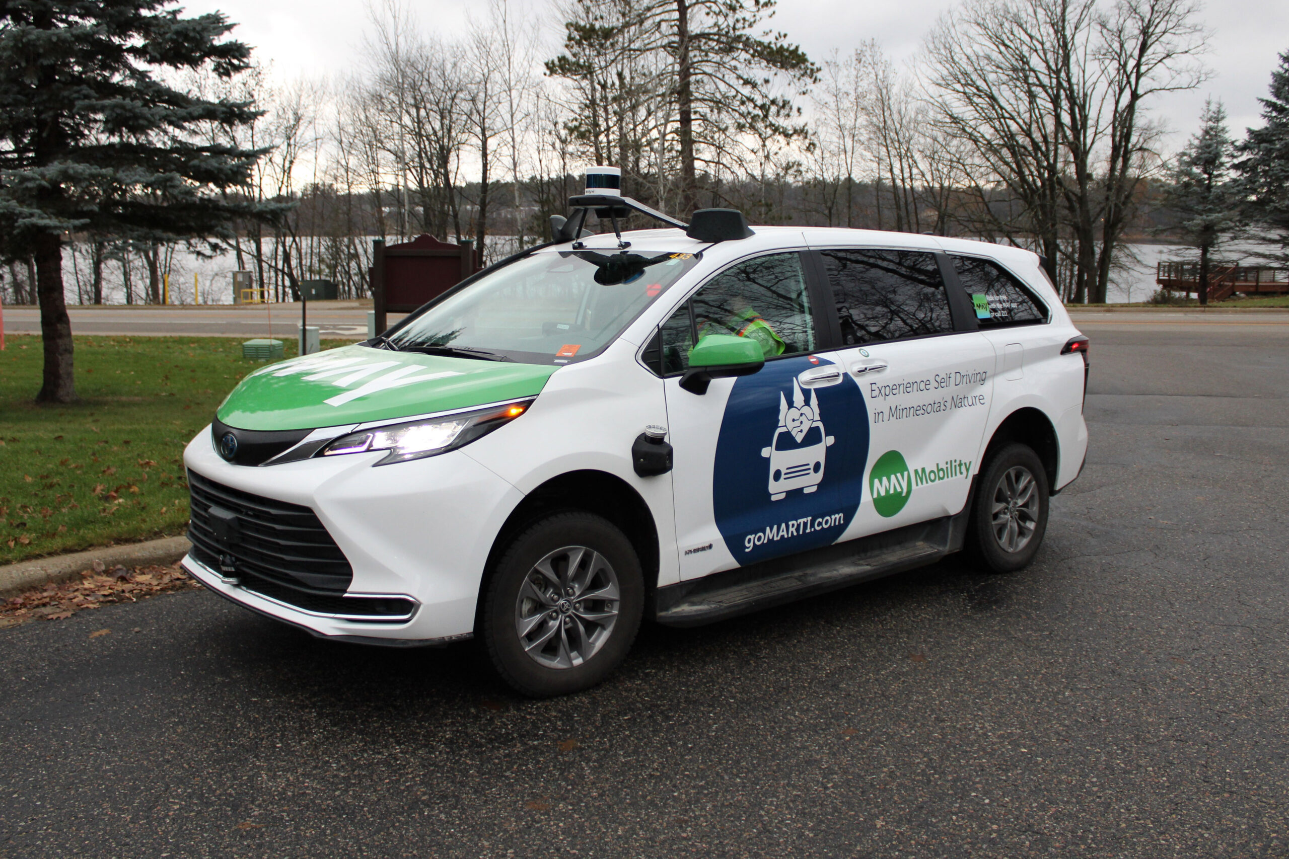 The goMARTI vehicle, a white van painted with green and blue branding, is parked outside.